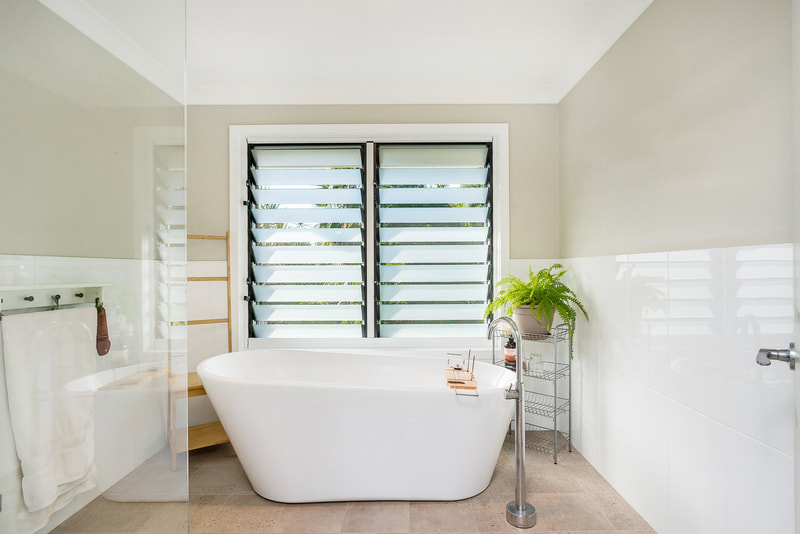 Lismore bathroom renovation with a beautiful deep free standing bath, louvre windows, heat light and plenty of space. 