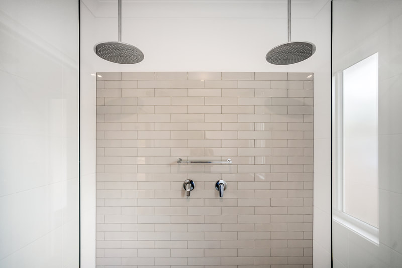 double shower luxury with gorgeous subtle grey subway tiles. 