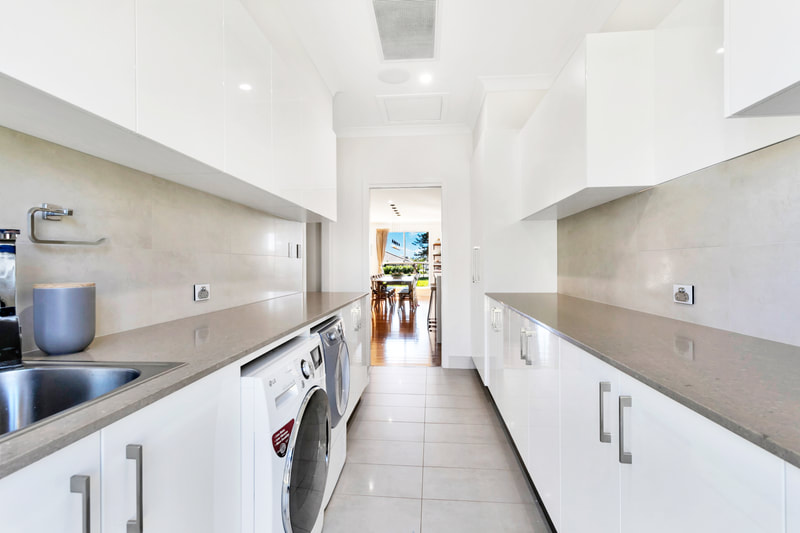 very large modern laundry renovation with plenty of bench and cupboard space.